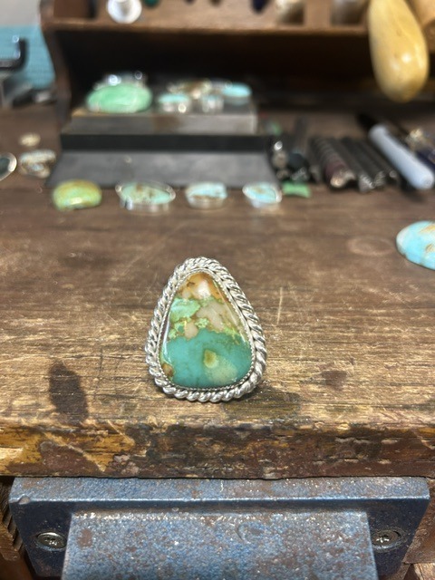 Green Royston turquoise ring with twisted-rope silver bezel on the L3 Designs bench